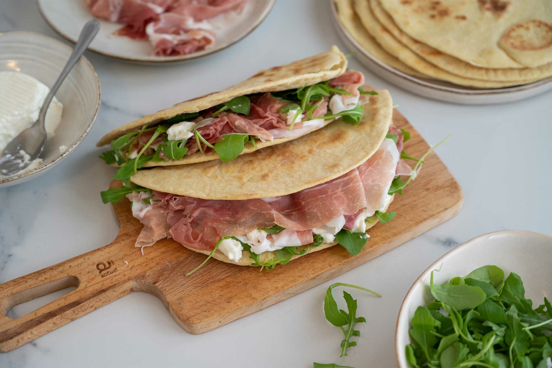 Piadina(flatbread) with Prosciutto di San Daniele, arugula and squacquerone cheese (soft cheese)