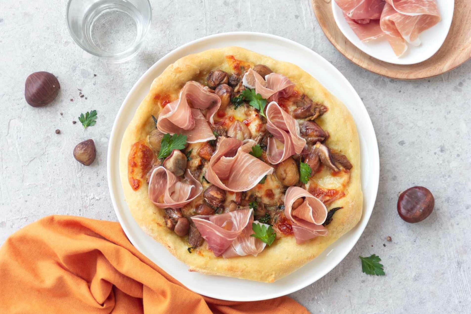 Pizza with chestnuts, mushrooms, Prosciutto di San Daniele and smoked scamorza cheese