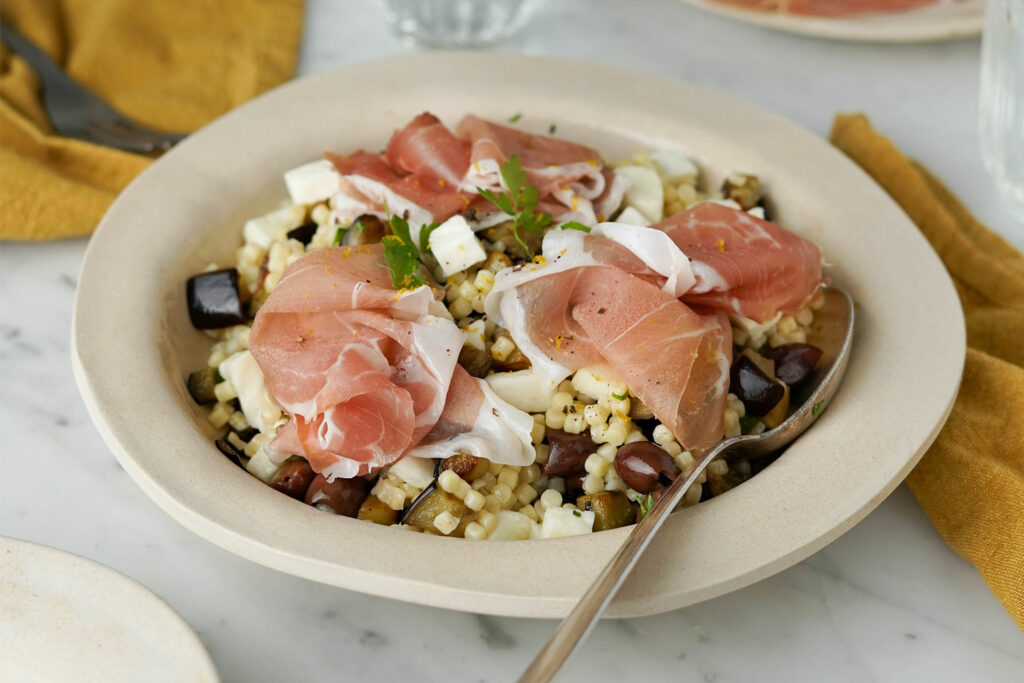 Insalata di fregola con melanzana a cubetti, mozzarella, olive e Prosciutto di San Daniele