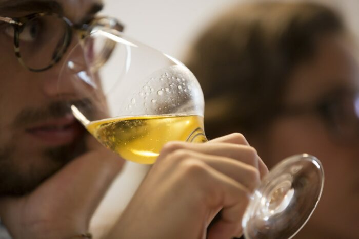 persona che si porta il calice di birra alla bocca per la desgustazione