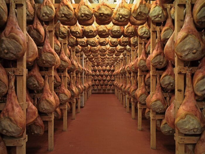 veduta di un prosciuttificio con i Prosciutti di San Daniele DOP appesi