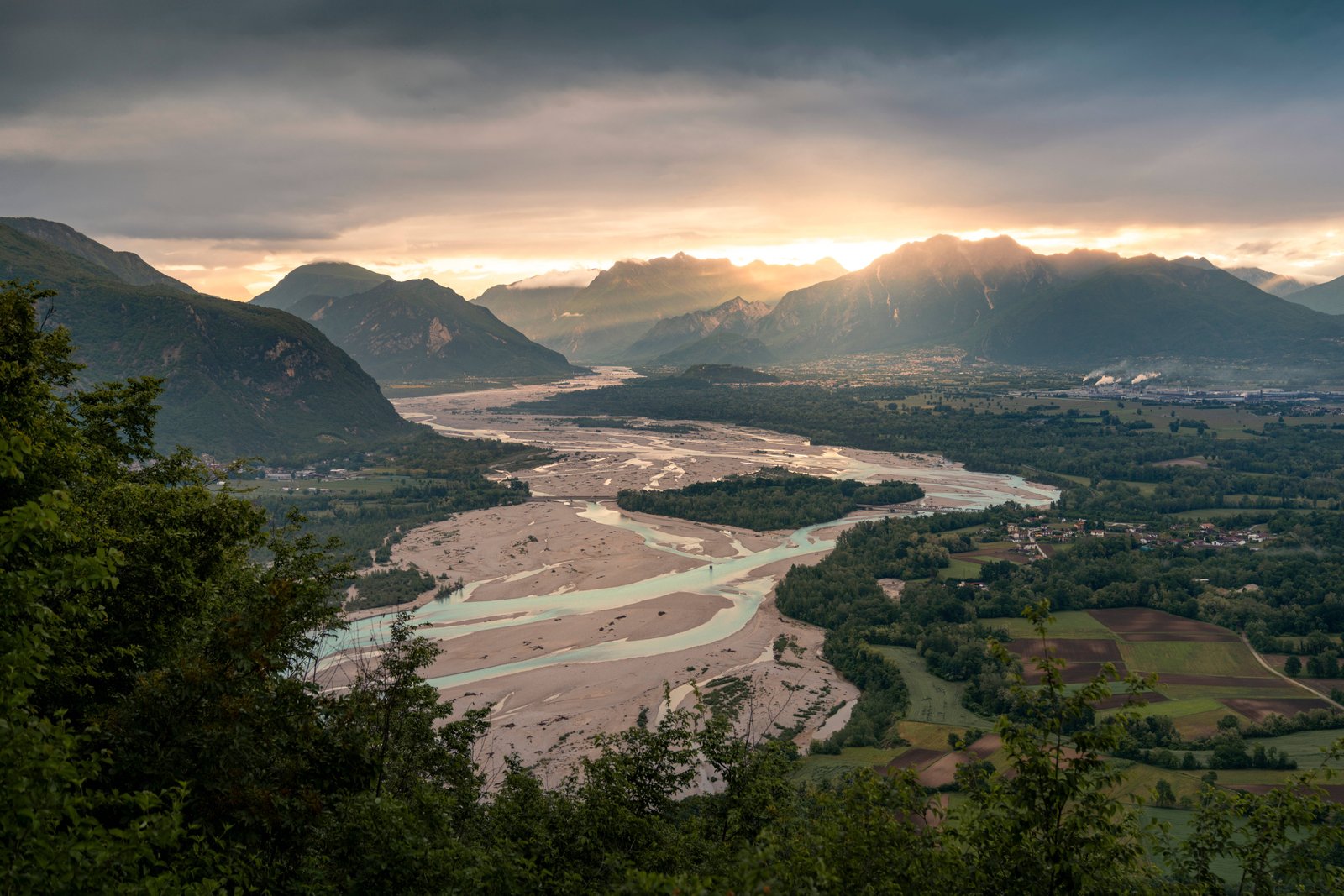 Veduta della valle del Tagliamento al tramonto, con la luce dorata che filtra tra le Prealpi del Friuli Venezia Giulia