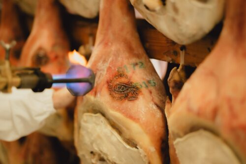 Marchiatura a fuoco di un Prosciutto di San Daniele DOP, con il contrassegno del Consorzio impresso sulla cotenna